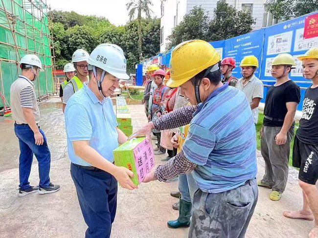 岑廷義為一線工人發(fā)放清涼飲品。 謝秋云 攝（650圖）.jpg